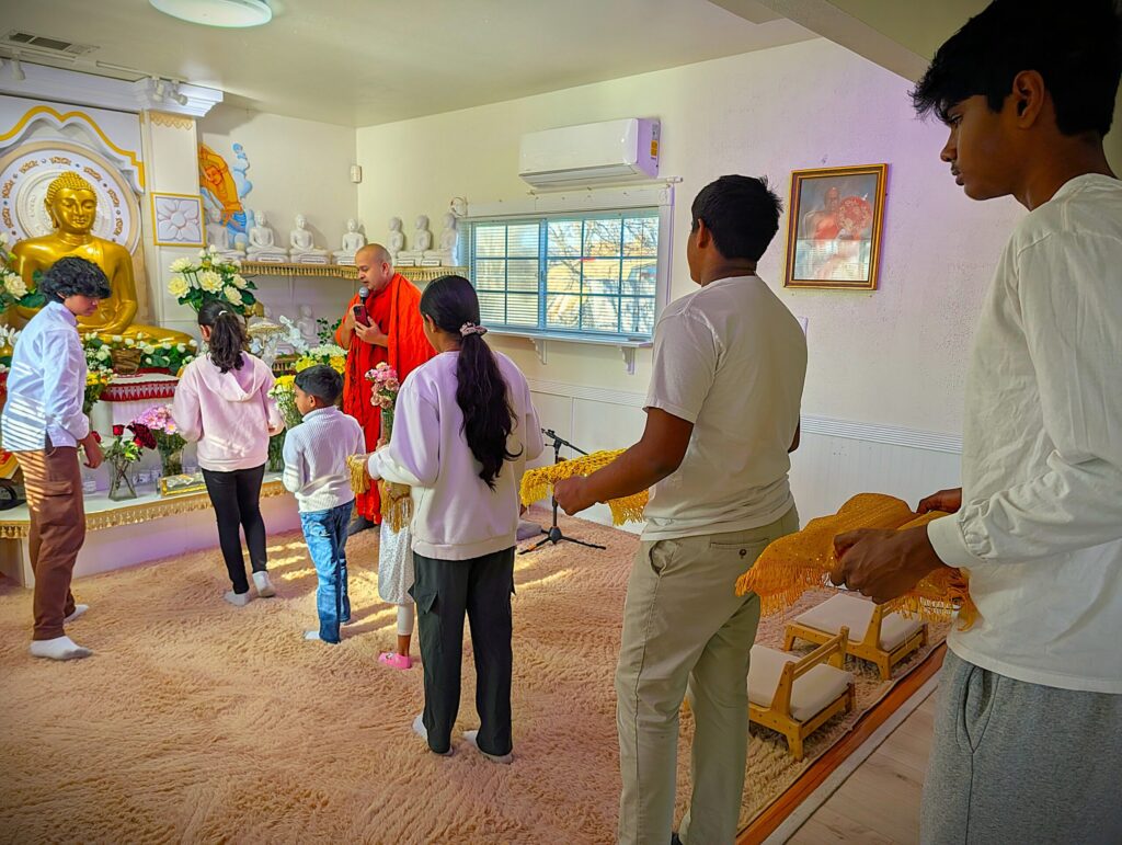 Students and youth volunteers leading a ceremonial procession of offerings before the worship service.